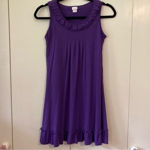 Purple tank dress with ruffle at neck and bottom.